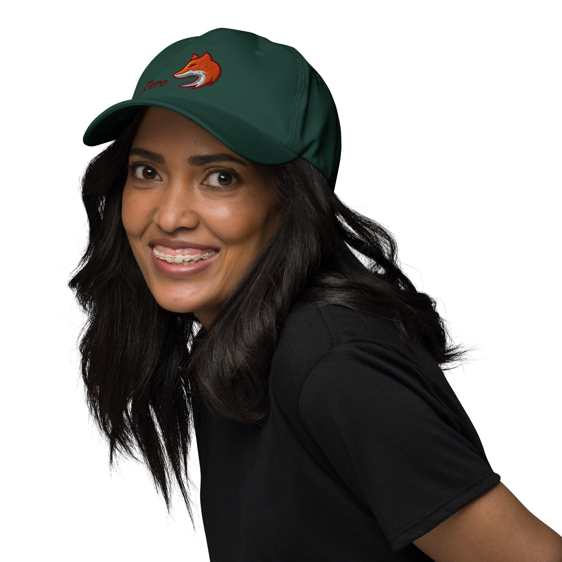 Woman wearing green baseball cap with embroidered fox and the word "Zero" on the front, suggesting the phrase "Zero Fox" or "Zero Fcks."