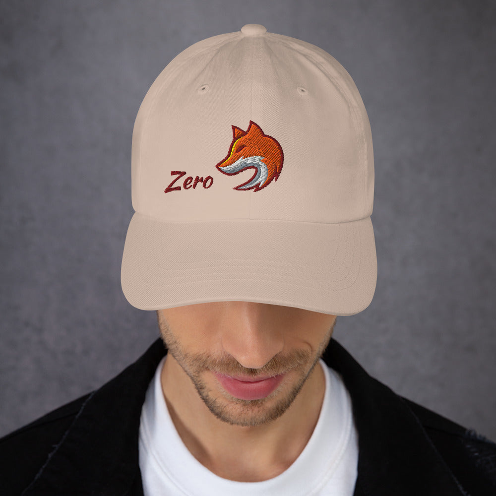 Man wearing stone baseball cap with embroidered fox and the word "Zero" on the front, suggesting the phrase "Zero Fox" or "Zero Fcks."